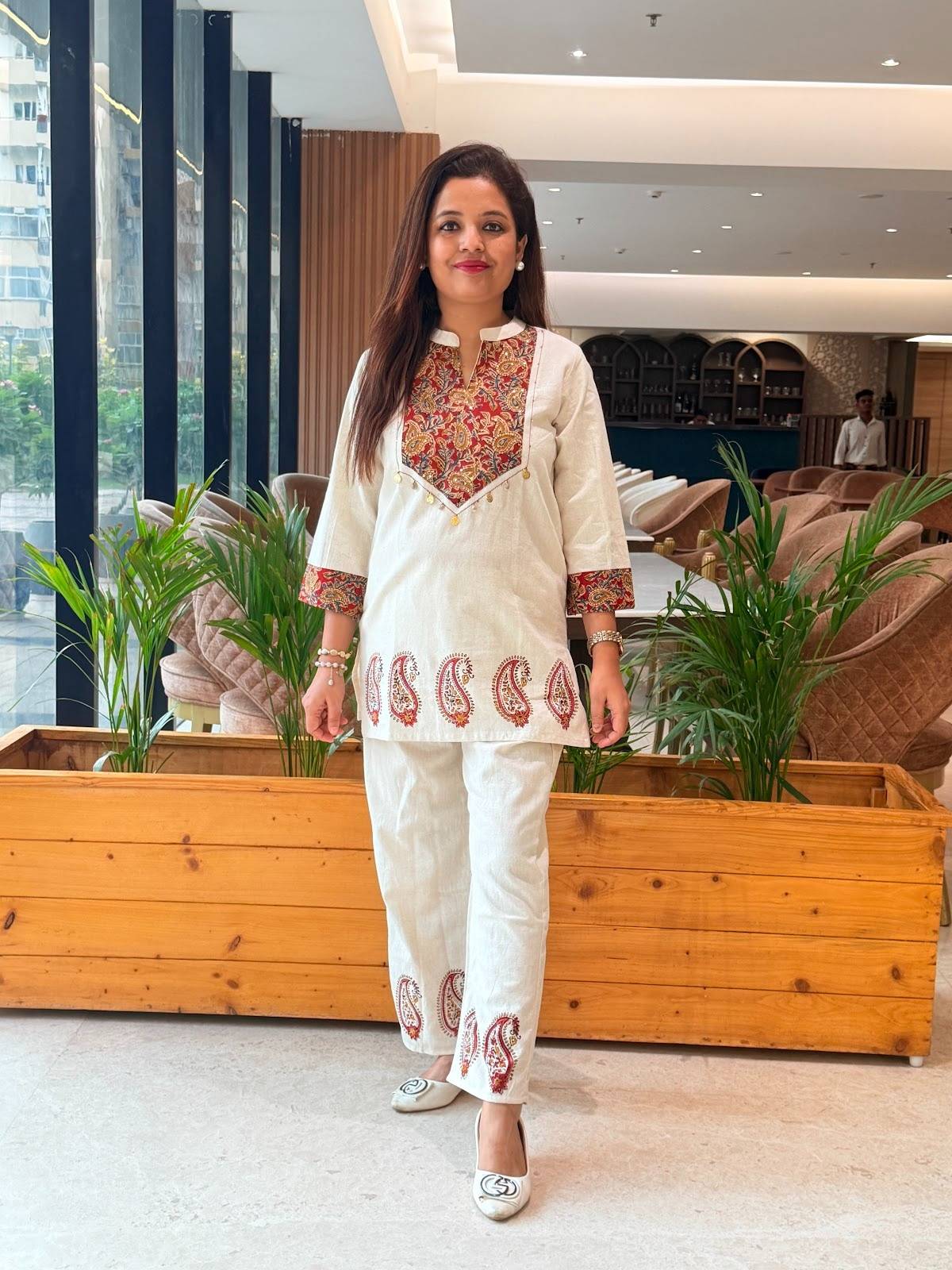 cotton co-ord set featuring a tunic with colorful ethnic embroidery and matching paisley-printed ankle-length pants