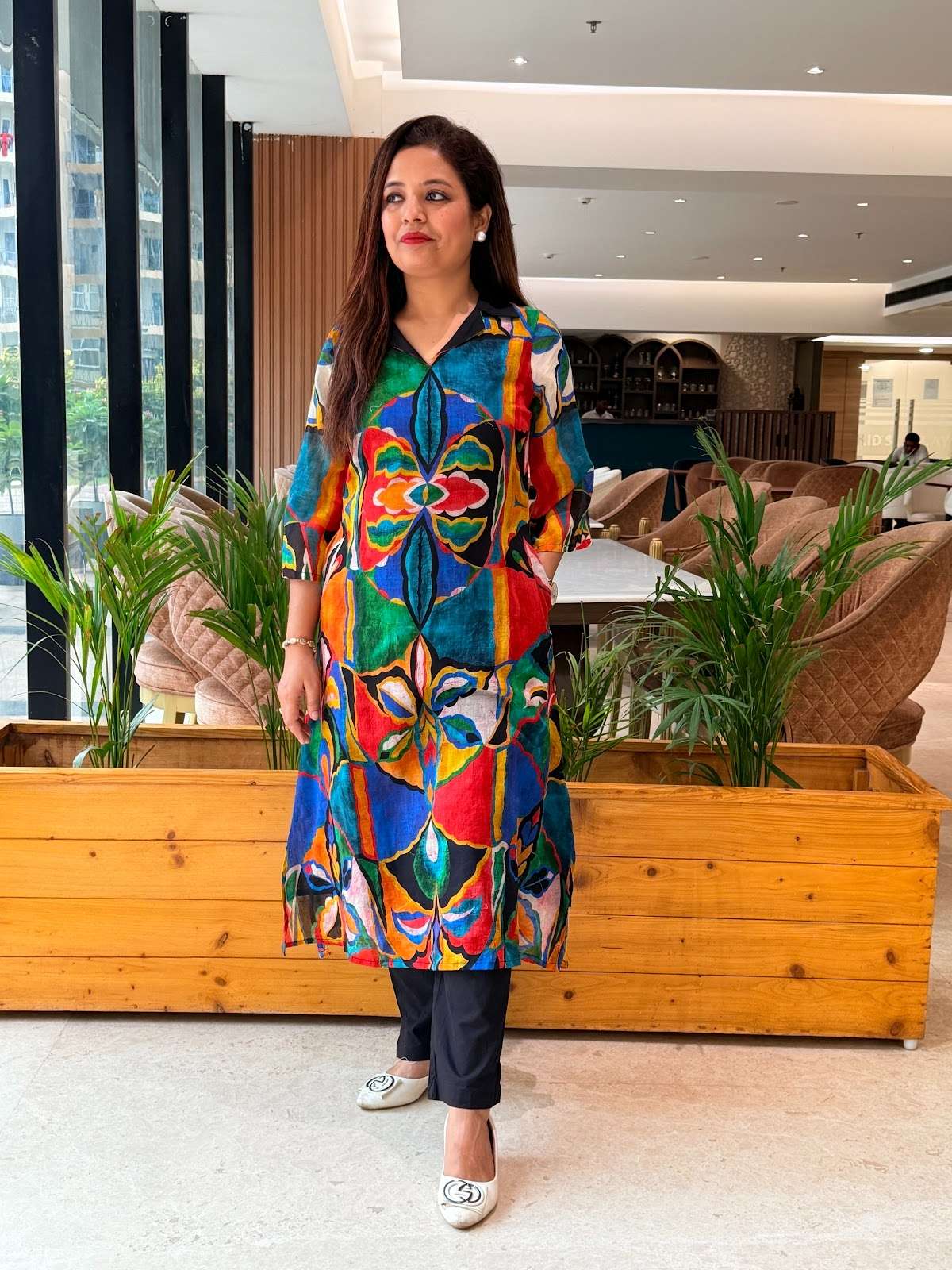 A vibrant multi-color digital print mul-cotton kurta pant set with lining and paired with solid black pants