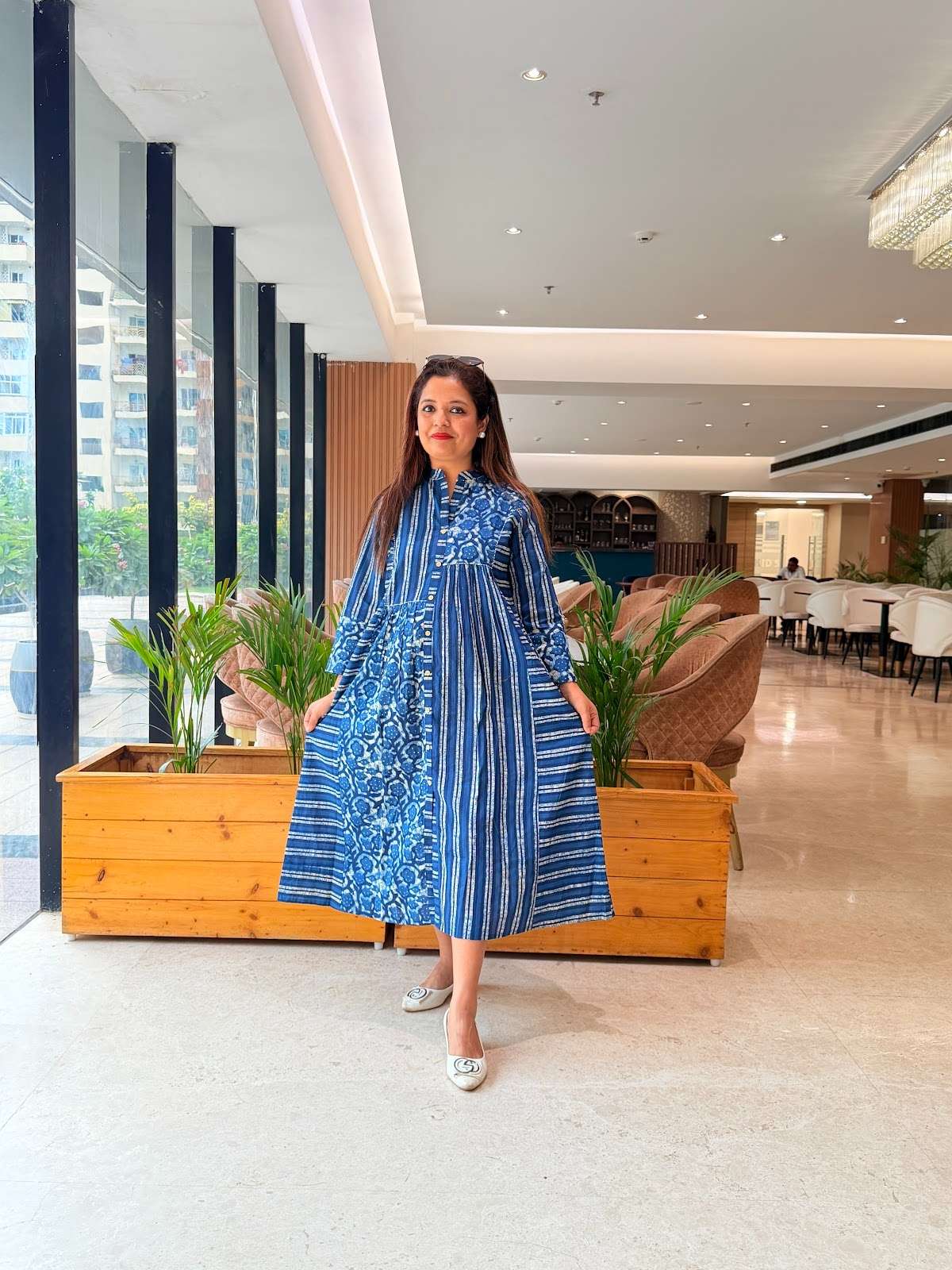 blue and white patterned cotton A-line midi dress with a button-up front and distinct striped and floral block-print panels