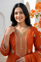 Vibrant orange ethnic sharara set intricate gold zari embroidery