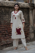 Flex cotton  kurta set features unique jute applique patchwork and maroon V-neck detailing