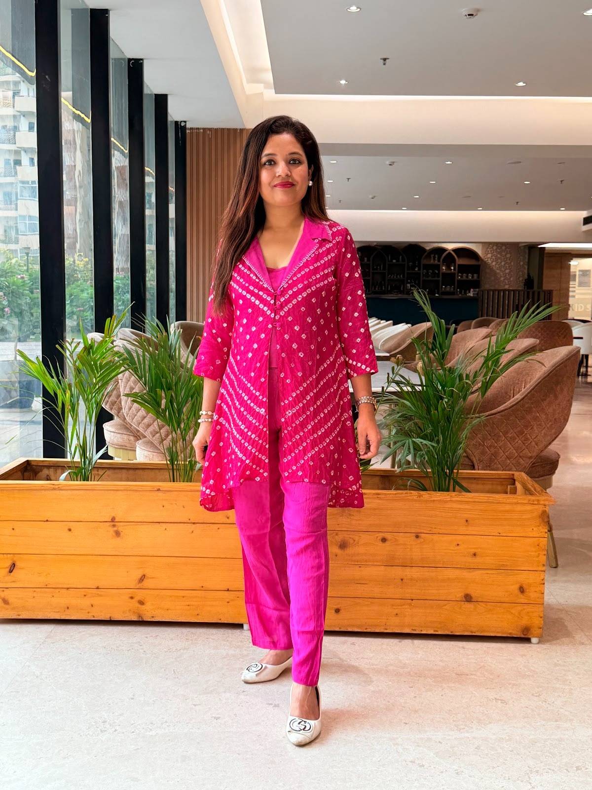 fuchsia pink co-ord set featuring traditional bandhani patterns, paired with a matching long jacket, straight-cut pants