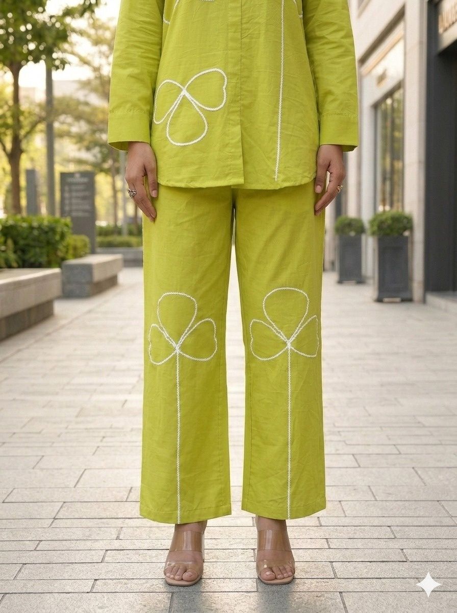 Green Pure cotton co-ord set featuring white appliqué clover or shamrock-style floral details along the front of the tunic and pants