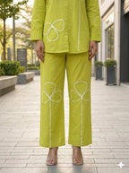 Green Pure cotton co-ord set featuring white appliqué clover or shamrock-style floral details along the front of the tunic and pants