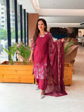 maroon V-neck kurta suit set with delicate white floral threadwork along the neckline and hem, paired with a matching printed dupatta
