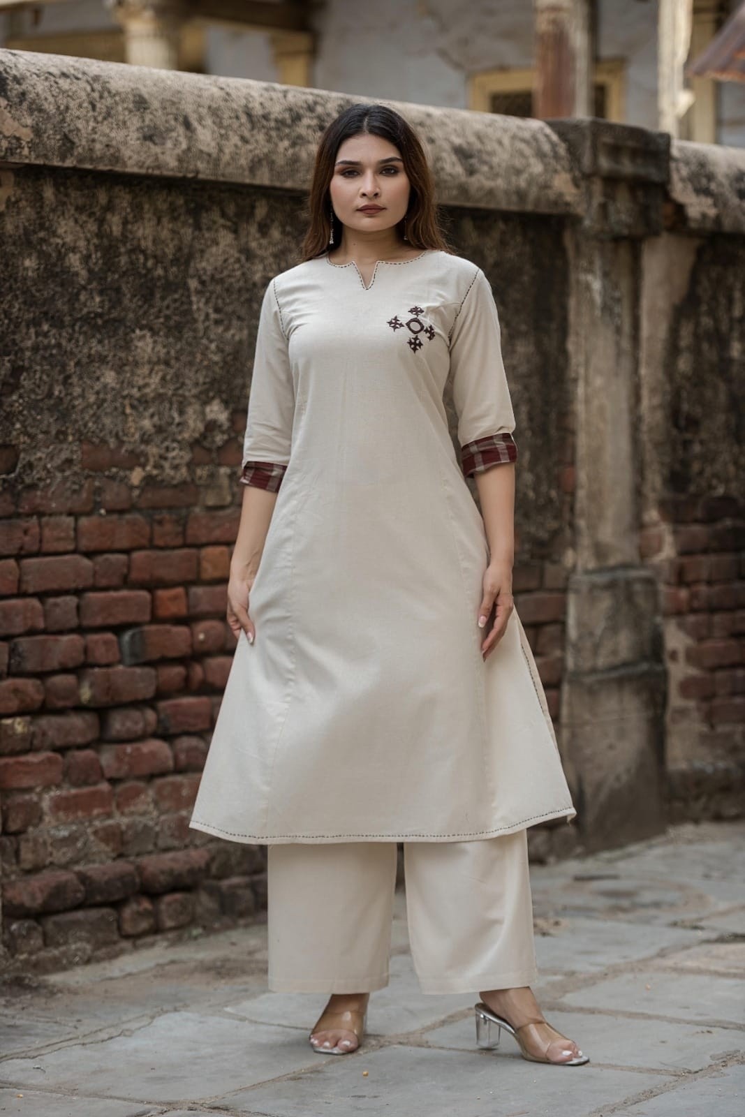 Off White cotton blend kurta and palazzo set featuring contrast plaid sleeve cuffs and dark chest embroidery