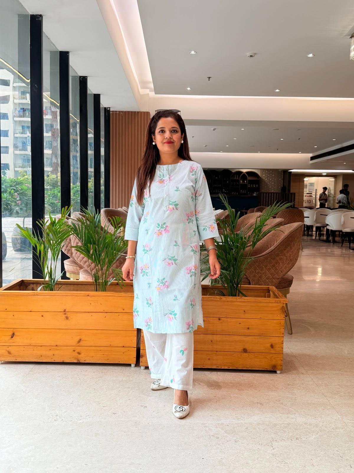 Pure cotton light blue floral printed kurta with flower motif embroidery paired with matching white wide-leg trousers