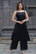 Strapy black sleeveless A-line kurta and matching palazzo pants featuring geometric red embroidery and mirror work along the neckline