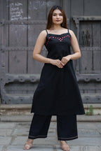 Strapy black sleeveless A-line kurta and matching palazzo pants featuring geometric red embroidery and mirror work along the neckline