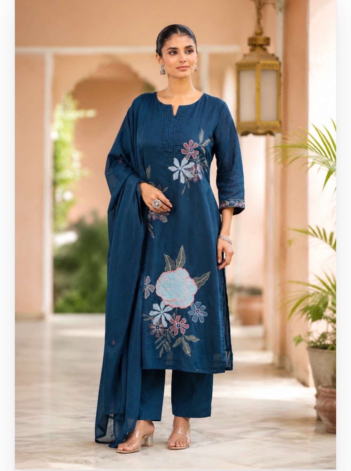 Teal blue cotton suit set with embroidered  delicate floral thread work, matching trousers, and a coordinating draped dupatta